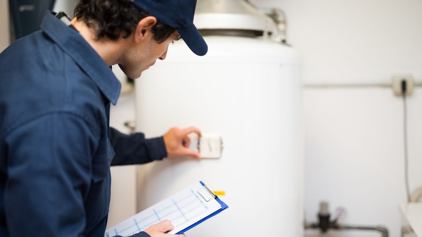 technician identifying signs of water heater failure