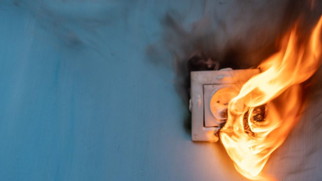 An electrical outlet on fire
