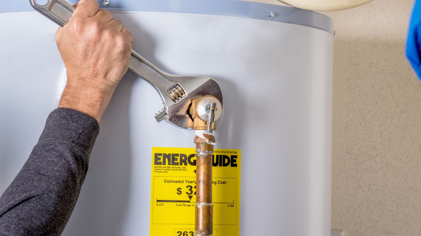 repairing water heater with wrench