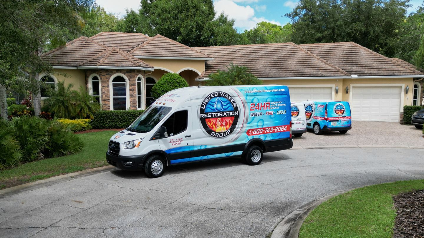 United Water Restoration Group Vans Outside Customer Home