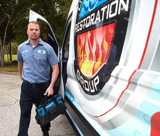 United Water Restoration Group professional walking out of his van