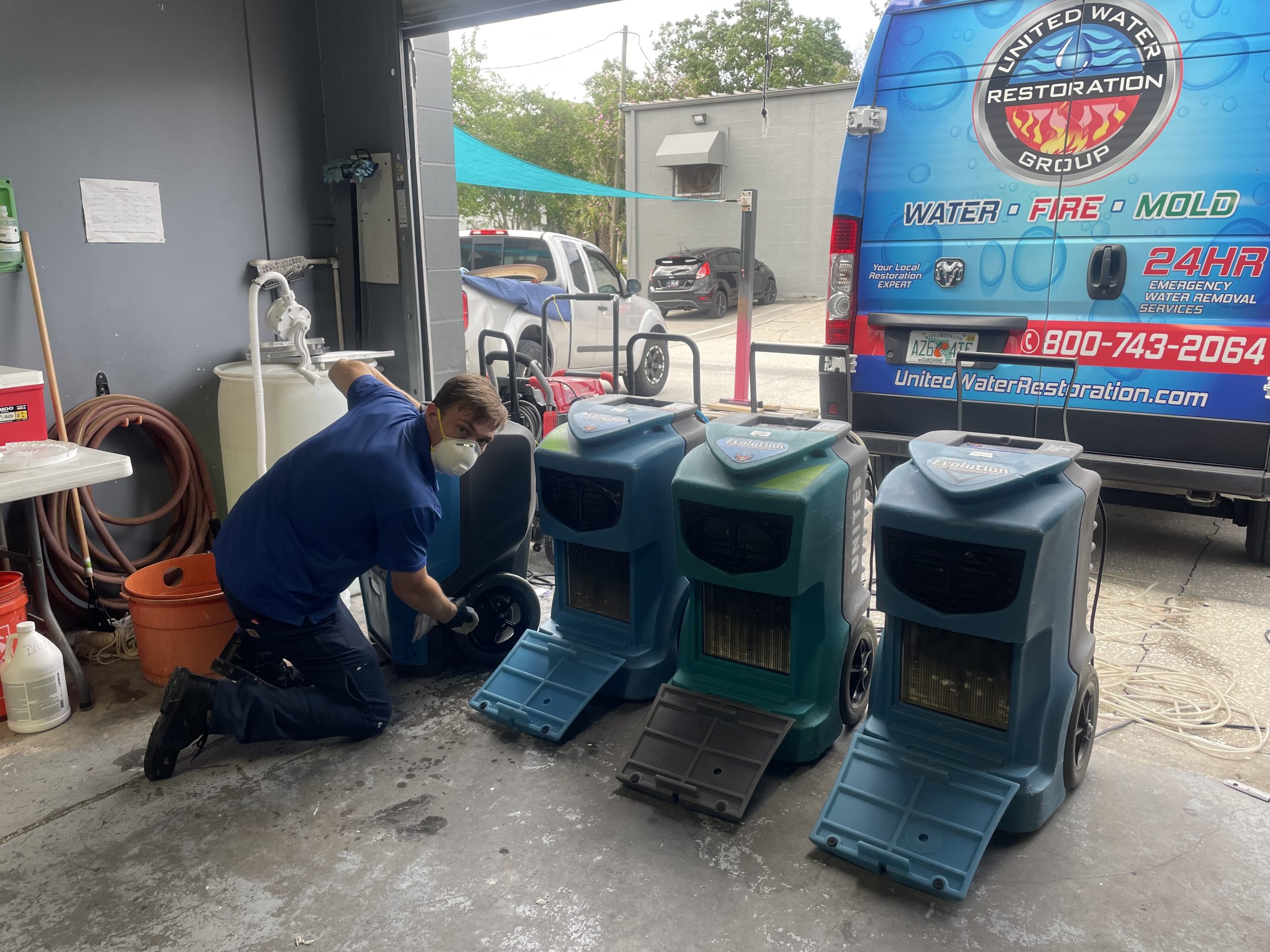 Professional water extraction equipment removing flood water during water damage restoration ormond beach, fl residential property.