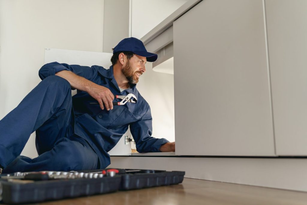 Professional technician repairing a home water damage issue