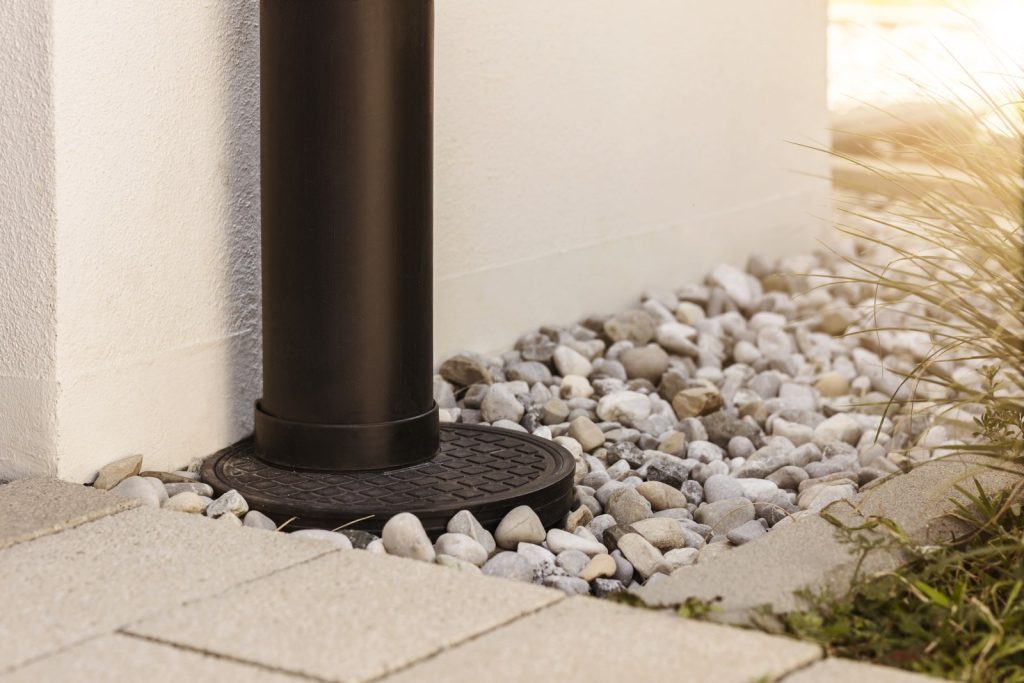 French drain carrying rainwater away from a home foundation