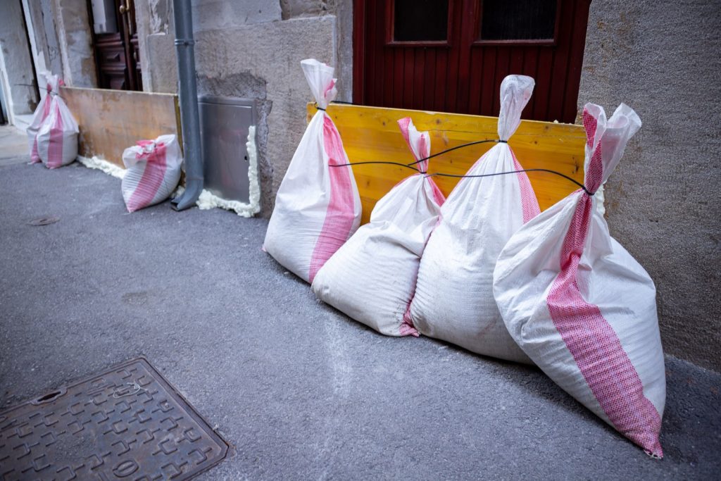 Sandbags placed outside a building entrance for flood protection