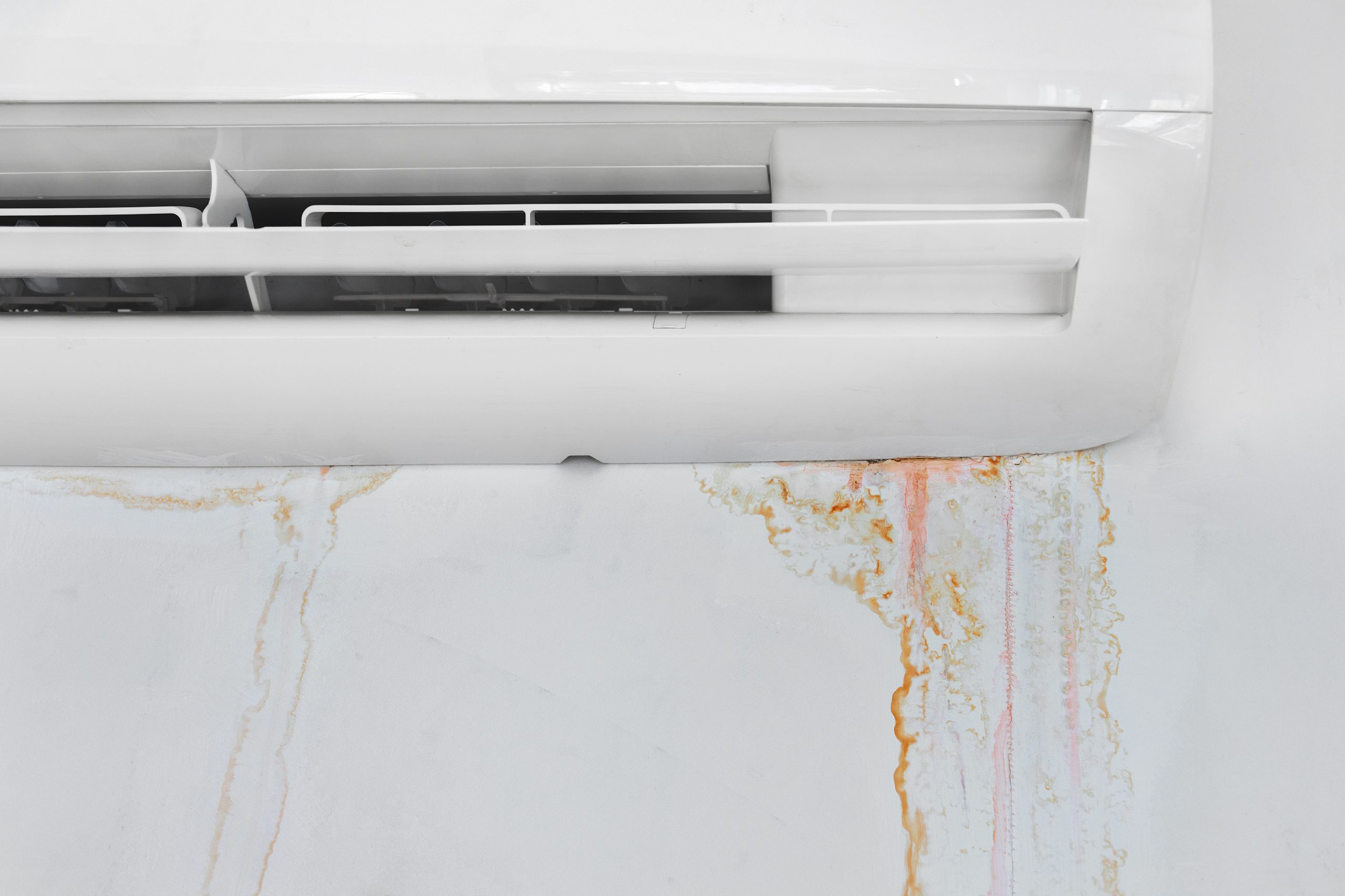 Wall with mold stain due to air conditioner leakage, close up. M